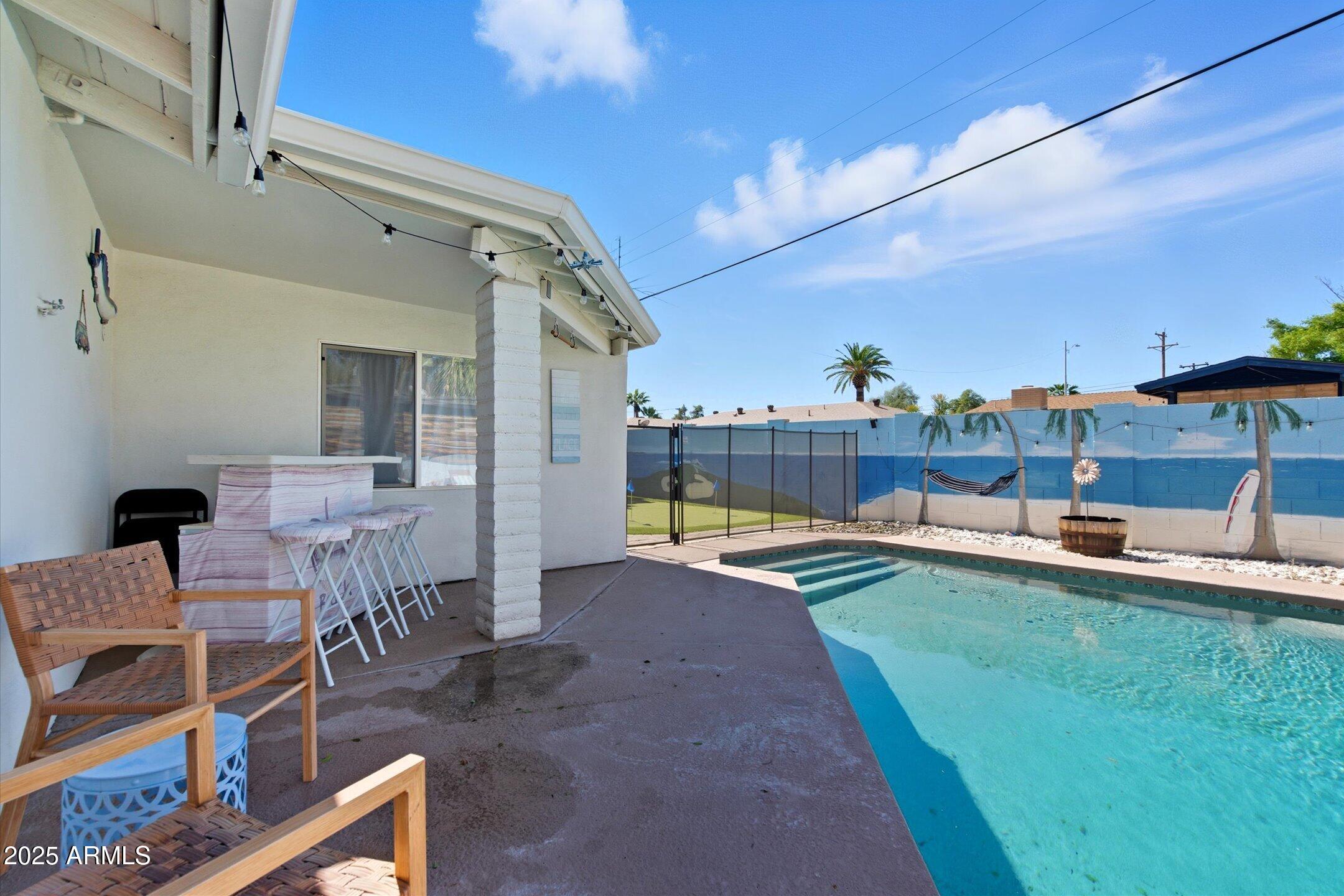 2530 North 68th Place Scottsdale, AZ 85257 - Photo 2 of 52 a view of a patio with dining table and chairs with wooden floor