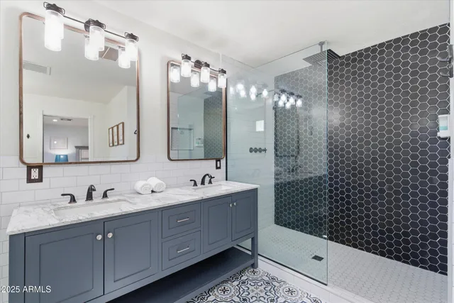 a bathroom with a bathtub sink mirror vanity and toilet