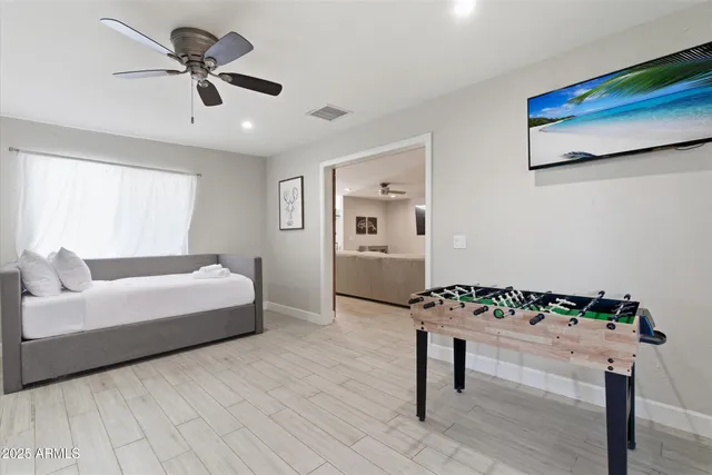 a bedroom with a bed and a window