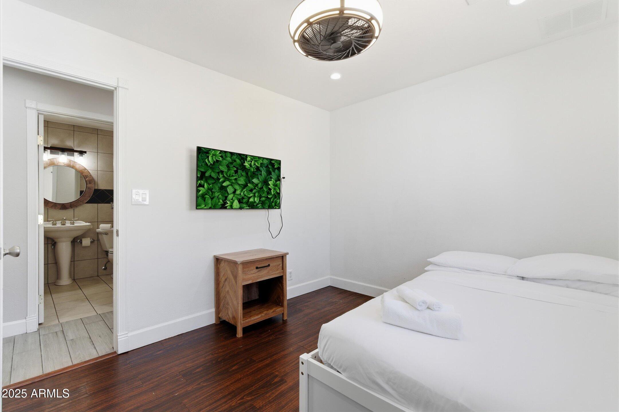 2530 North 68th Place Scottsdale, AZ 85257 - Photo 30 of 52 a bedroom with a bed and a television