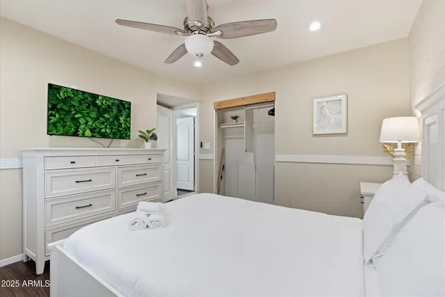 a bedroom with a bed and a night stand