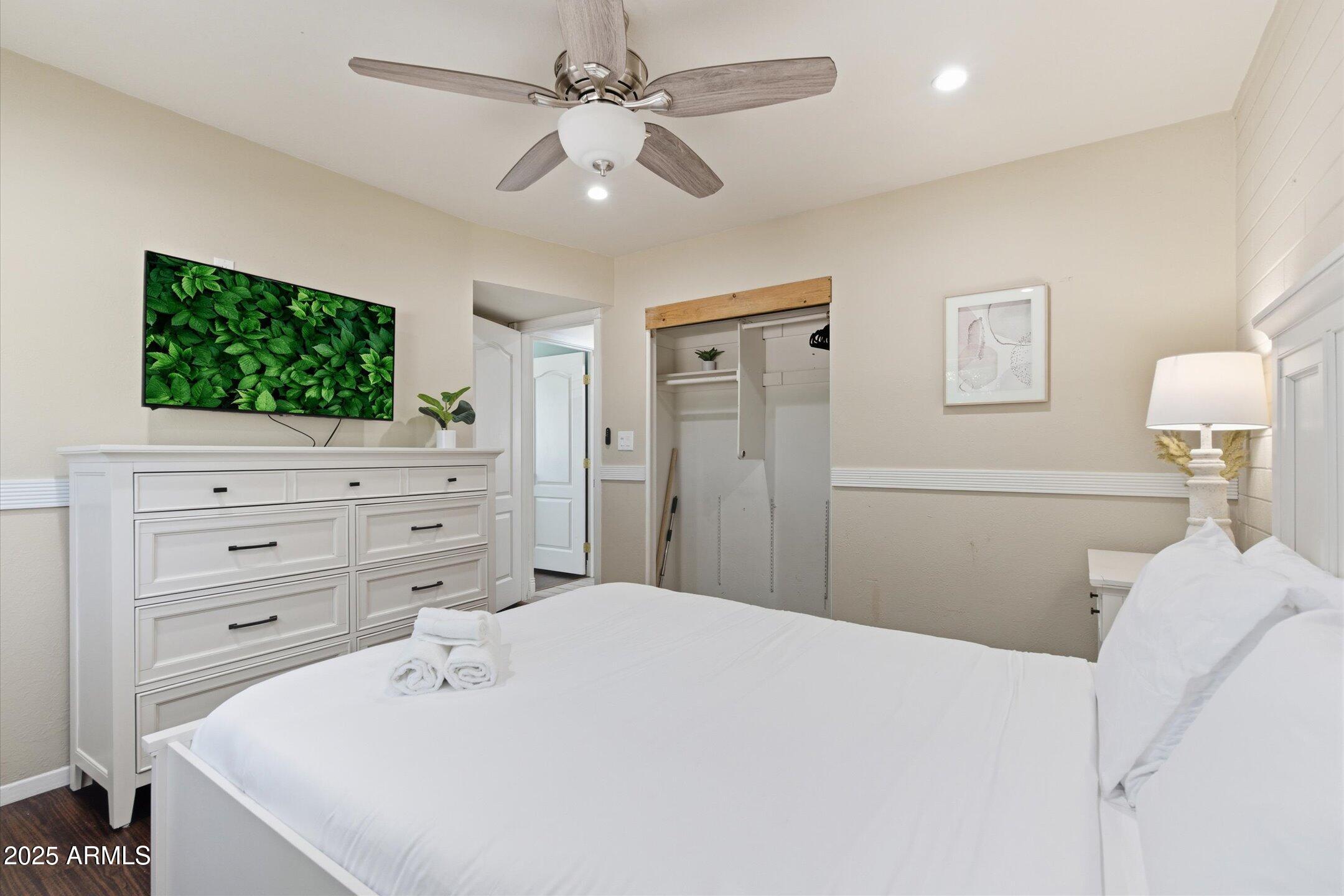 2530 North 68th Place Scottsdale, AZ 85257 - Photo 32 of 52 a bedroom with a bed and a flat screen tv