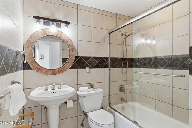 a living room with furniture kitchen view and a flat screen tv