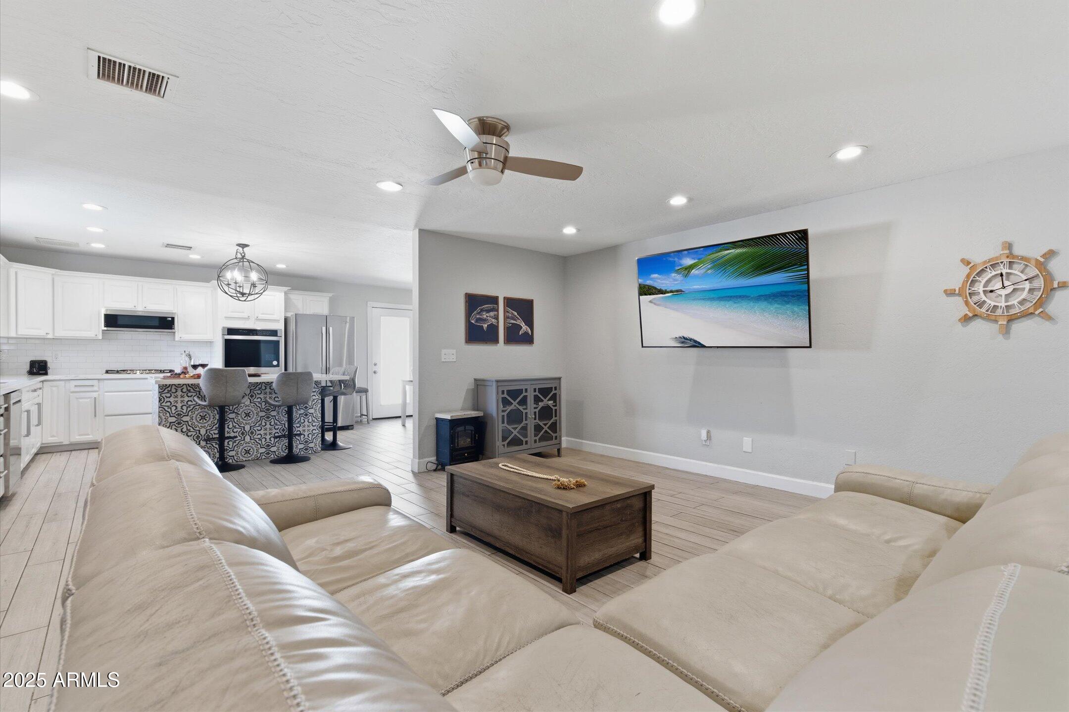 2530 North 68th Place Scottsdale, AZ 85257 - Photo 35 of 52 a living room with furniture kitchen view and a flat screen tv