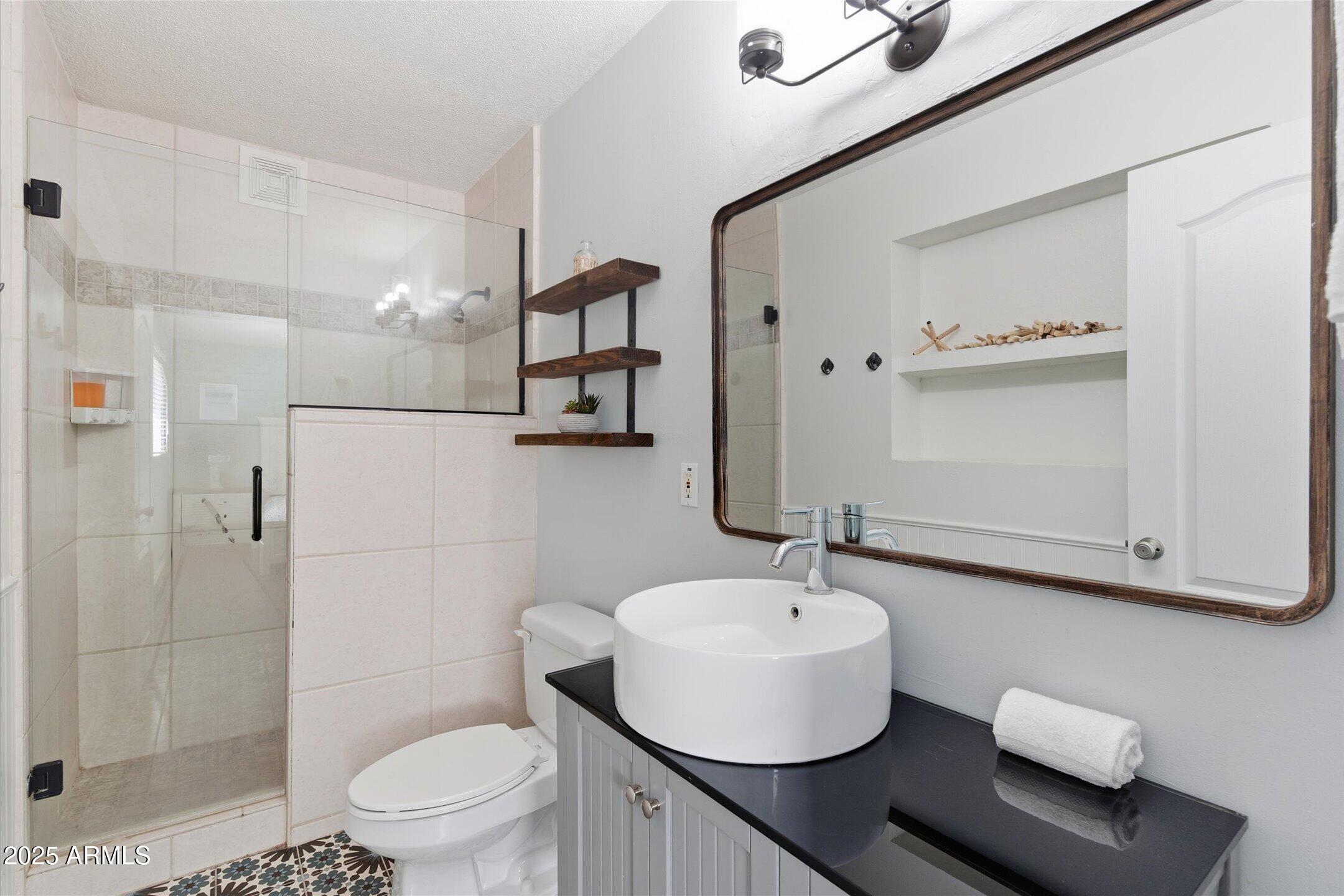 2530 North 68th Place Scottsdale, AZ 85257 - Photo 39 of 52 a bathroom with a sink toilet and shower