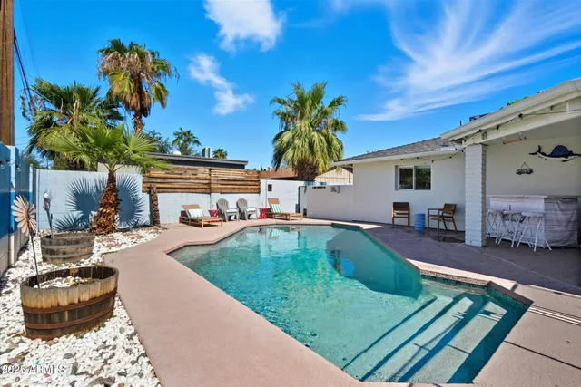 a view of a house with a yard and sitting area