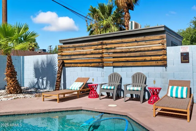 a swimming pool with outdoor seating and yard