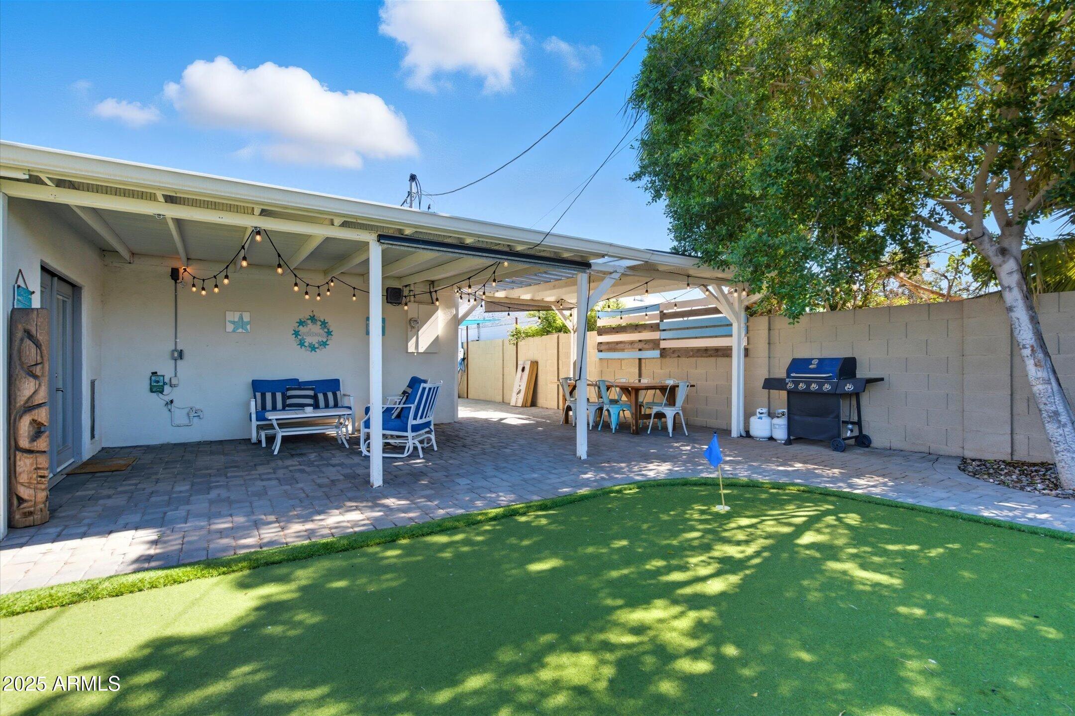 2530 North 68th Place Scottsdale, AZ 85257 - Photo 52 of 52 a view of a backyard with table and chairs and a barbeque