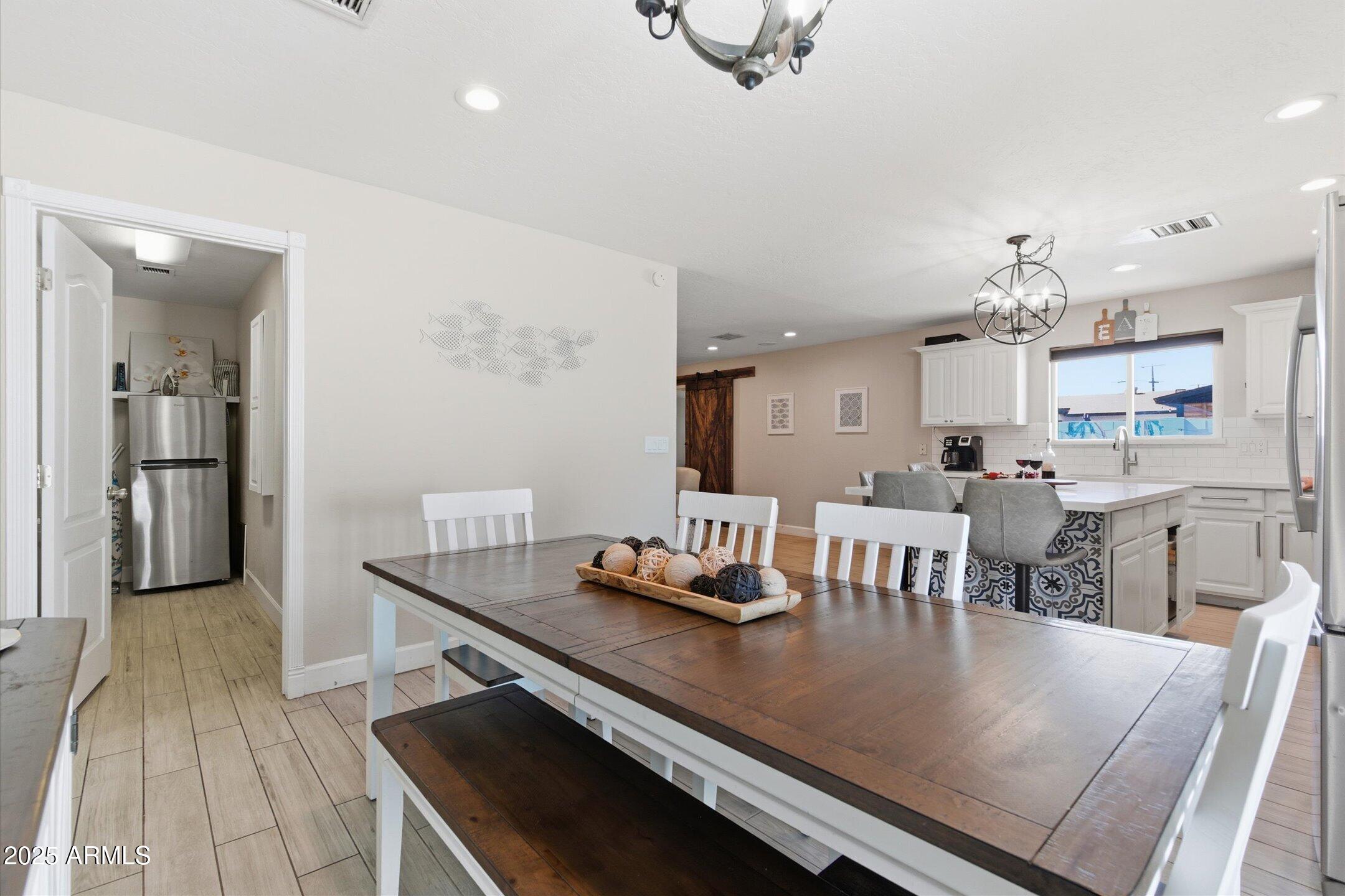 2530 North 68th Place Scottsdale, AZ 85257 - Photo 10 of 52 a living room with stainless steel appliances kitchen island a dining table and chairs