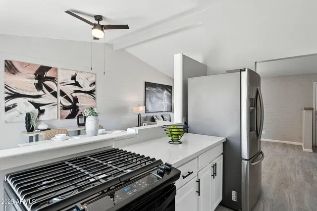 a kitchen with stainless steel appliances a sink a stove and cabinets