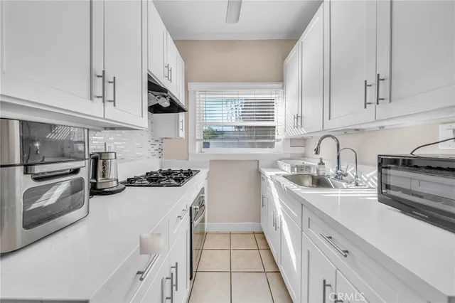 a kitchen with a sink stove and cabinets