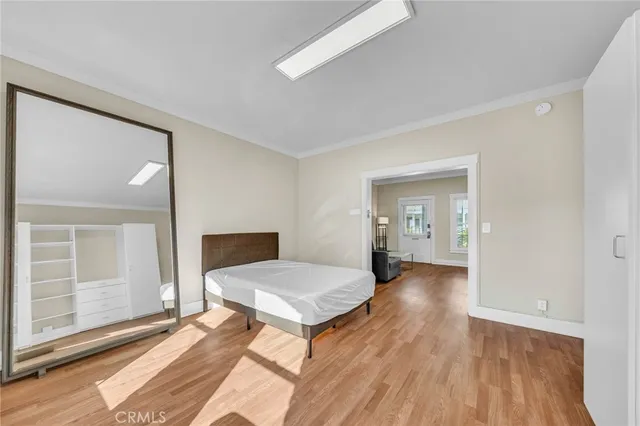a view of a room with wooden floor and furniture