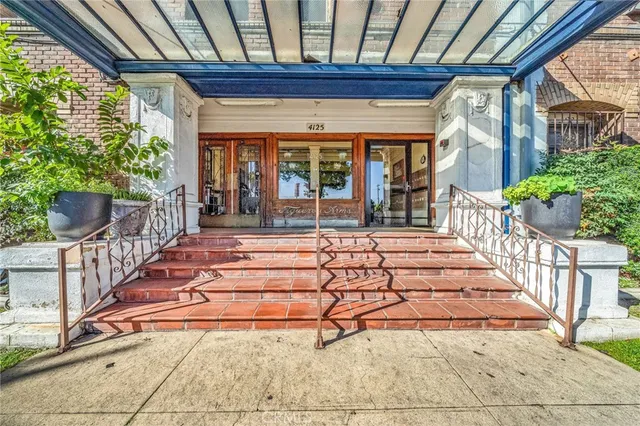 a view of a porch with wooden floor and iron stairs