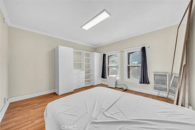 a bedroom with a bed and a large window