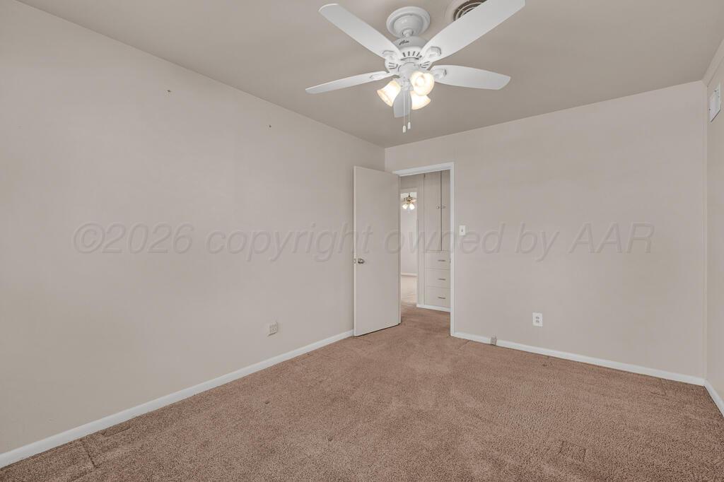 1606 Tularosa Street Amarillo, TX 79102 - Photo 16 of 22 an empty room with a chandelier fan