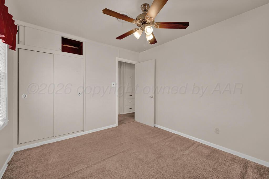 1606 Tularosa Street Amarillo, TX 79102 - Photo 17 of 22 an empty room with chandelier fan