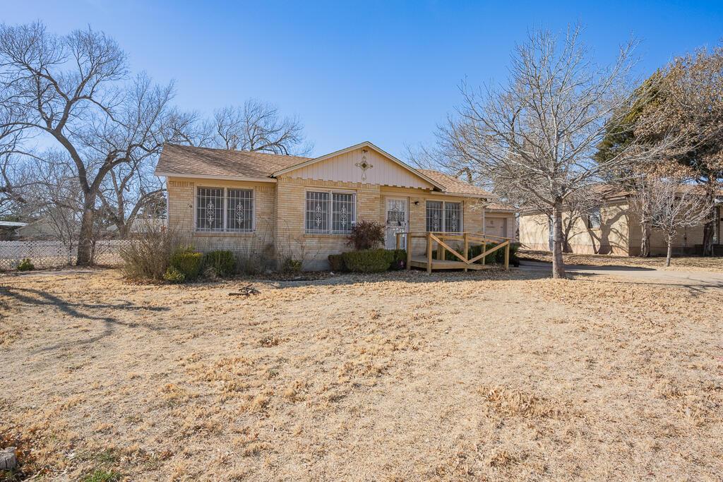 1606 Tularosa Street Amarillo, TX 79102 - Photo 22 of 22 a front view of a house with a yard covered in snow