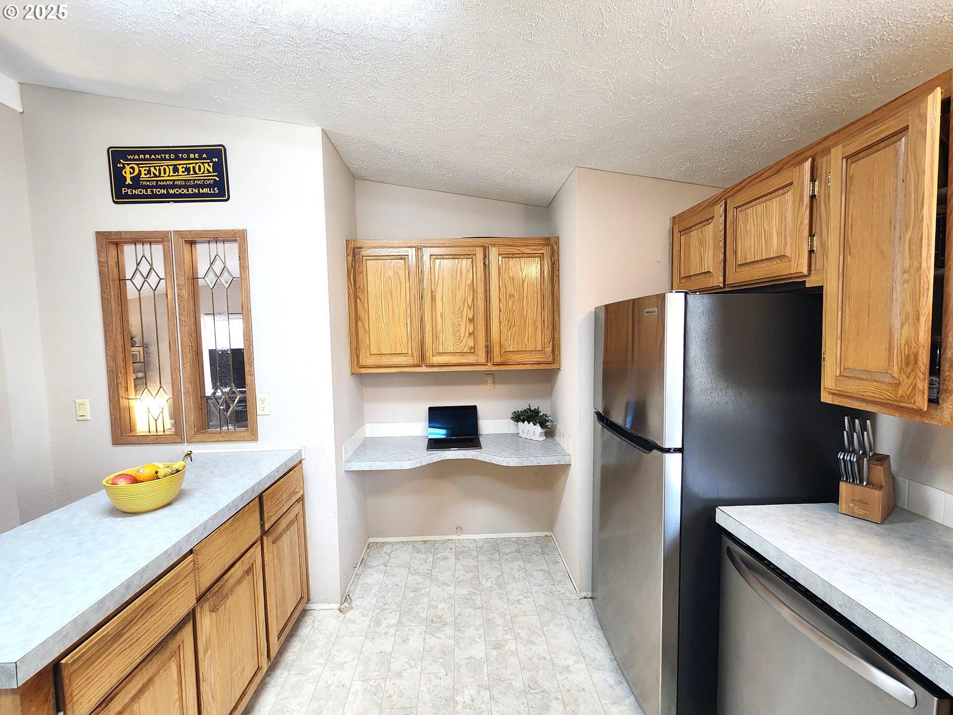 1809 26th Street, Unit 21 La Grande, OR 97850 - Photo 11 of 18 a kitchen with stainless steel appliances granite countertop a refrigerator and a sink