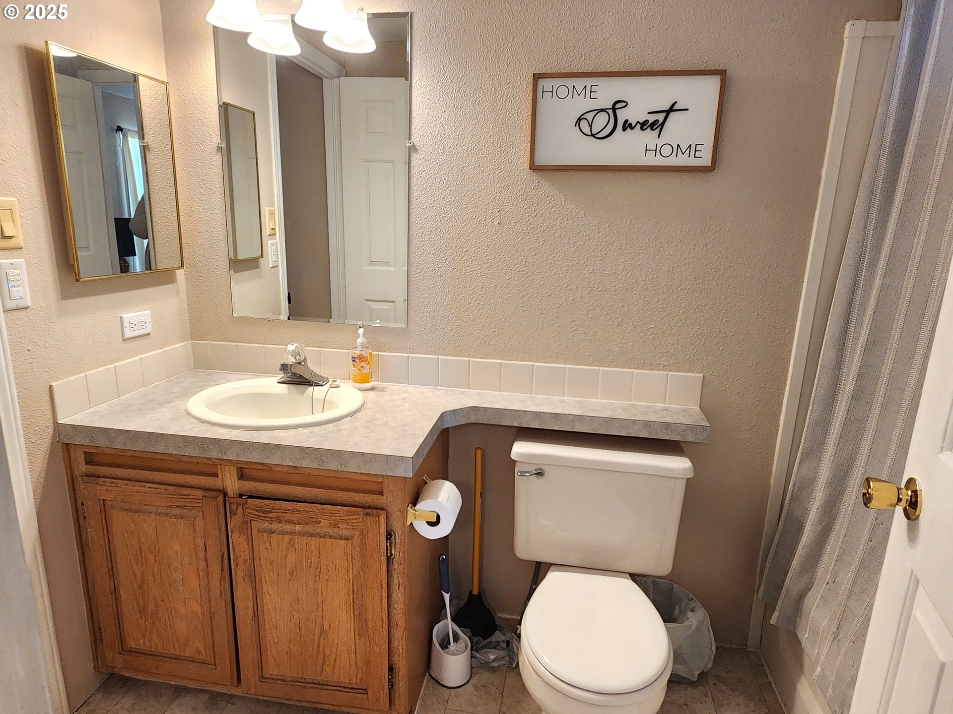 1809 26th Street, Unit 21 La Grande, OR 97850 - Photo 15 of 18 a bathroom with a toilet sink and mirror