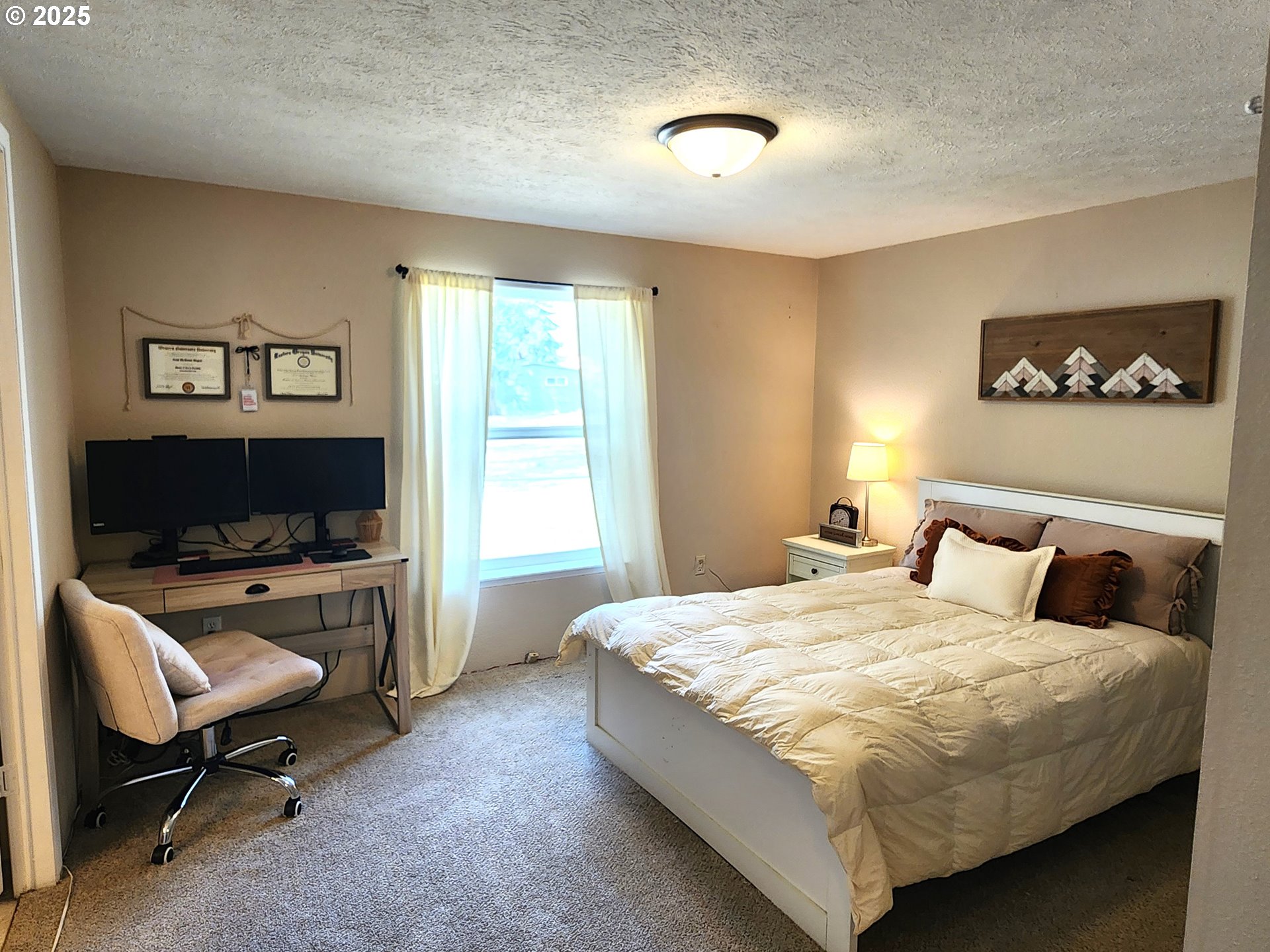 1809 26th Street, Unit 21 La Grande, OR 97850 - Photo 18 of 18 a bedroom with a bed and a couch