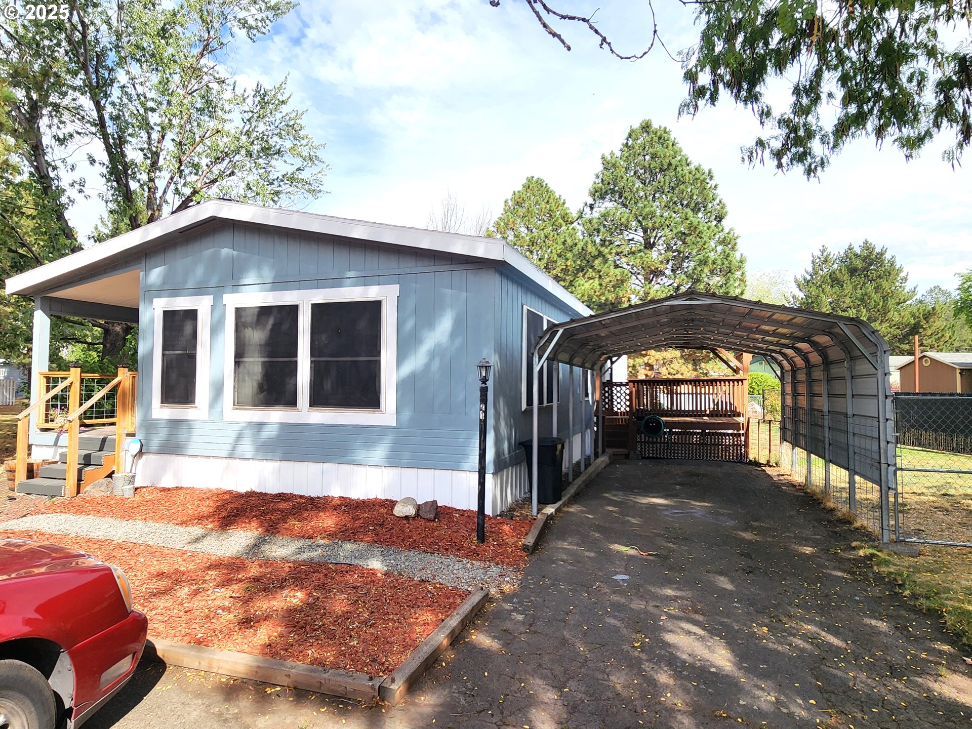1809 26th Street, Unit 21 La Grande, OR 97850 - Photo 2 of 18 a front view of a house with a yard
