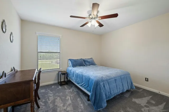 an aerial view of a house with a yard and lake view