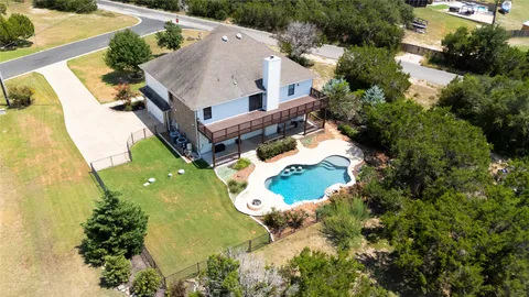 an aerial view of a house with a garden and swimming pool