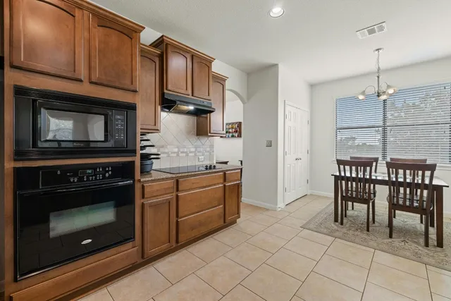 a living room with furniture and chandelier