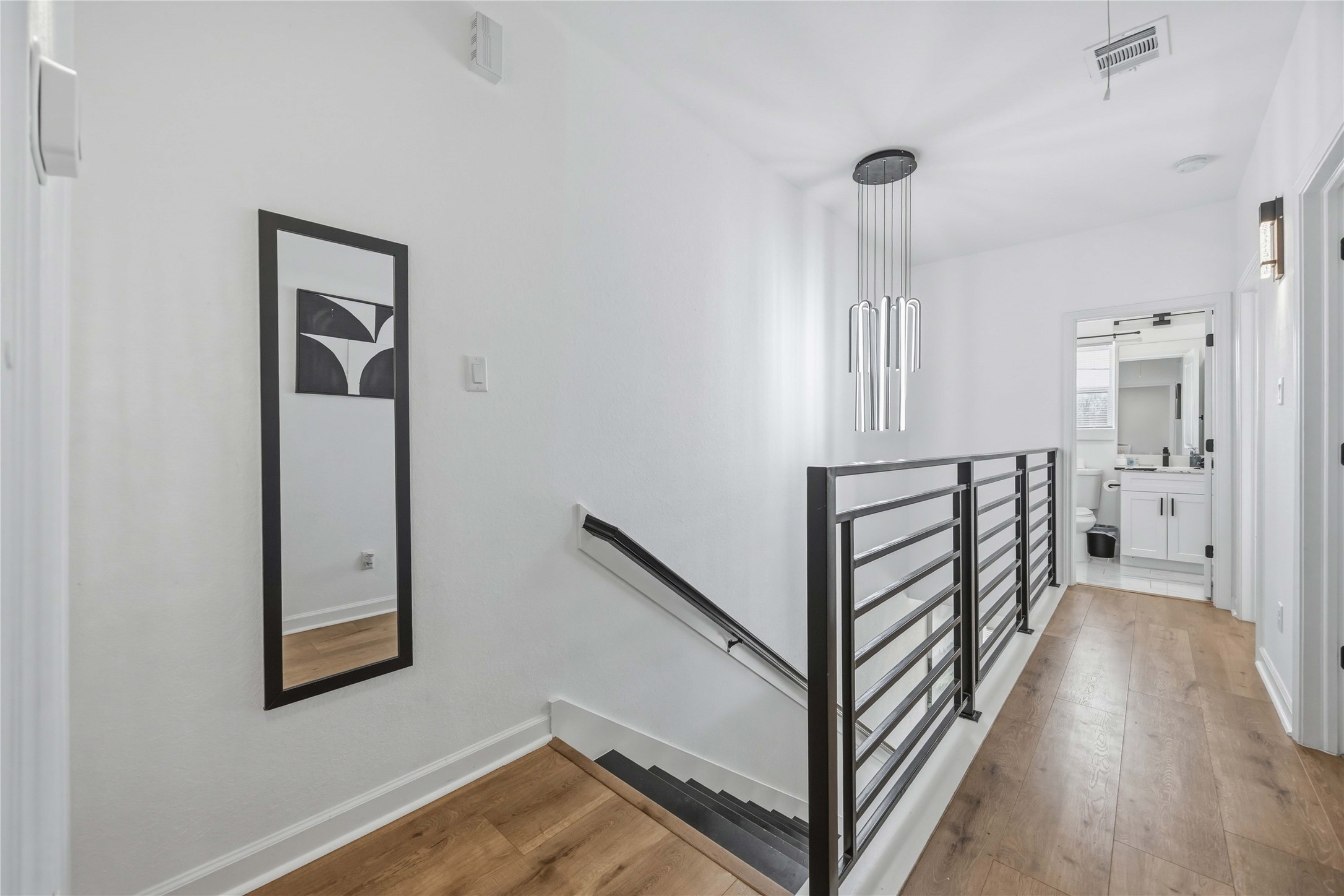 6130 Conley Street, Unit A Houston, TX 77021 - Photo 17 of 30 a view of a hallway with wooden floor and staircase