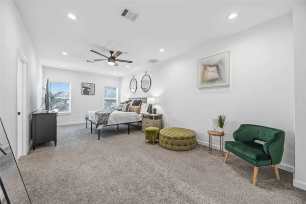 a living room with furniture and a ceiling fan