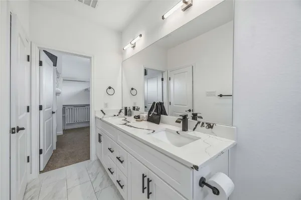 a bathroom with a sink double vanity and a mirror