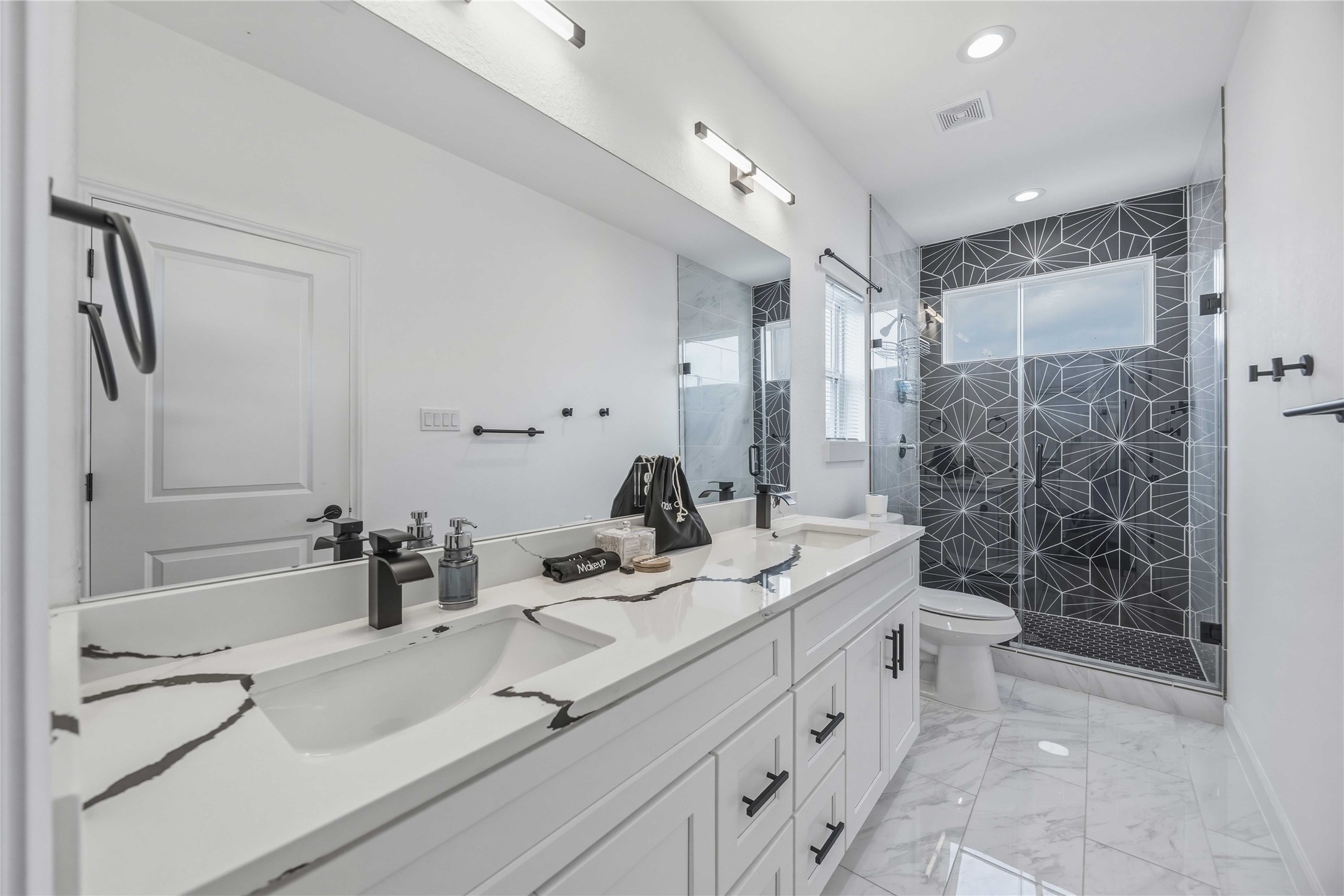 6130 Conley Street, Unit A Houston, TX 77021 - Photo 26 of 30 a bathroom with a double vanity sink toilet and shower