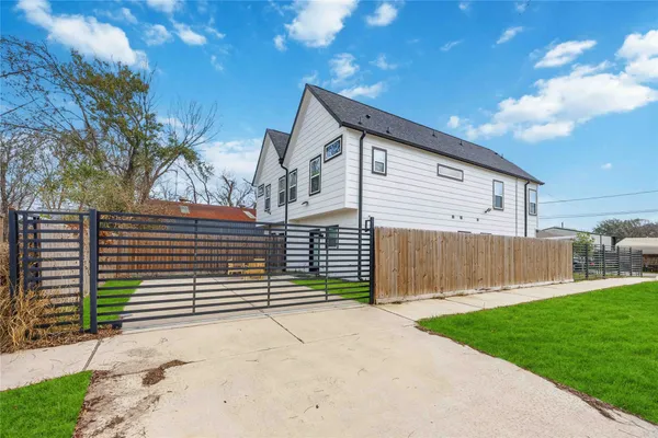 a view of a house with a yard and garage