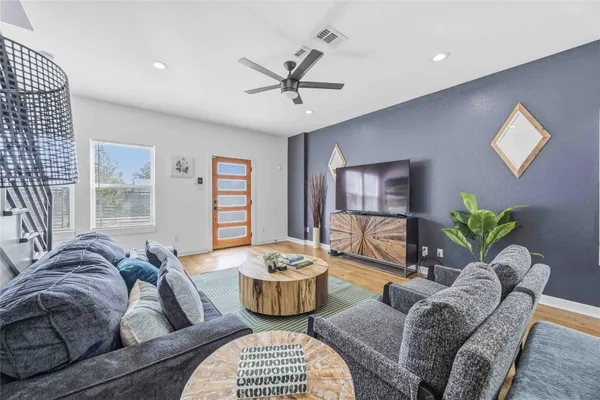 a living room with furniture and a potted plant