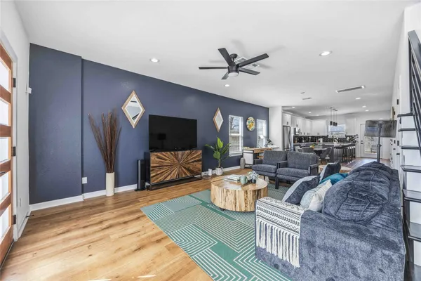 a living room with furniture and a flat screen tv