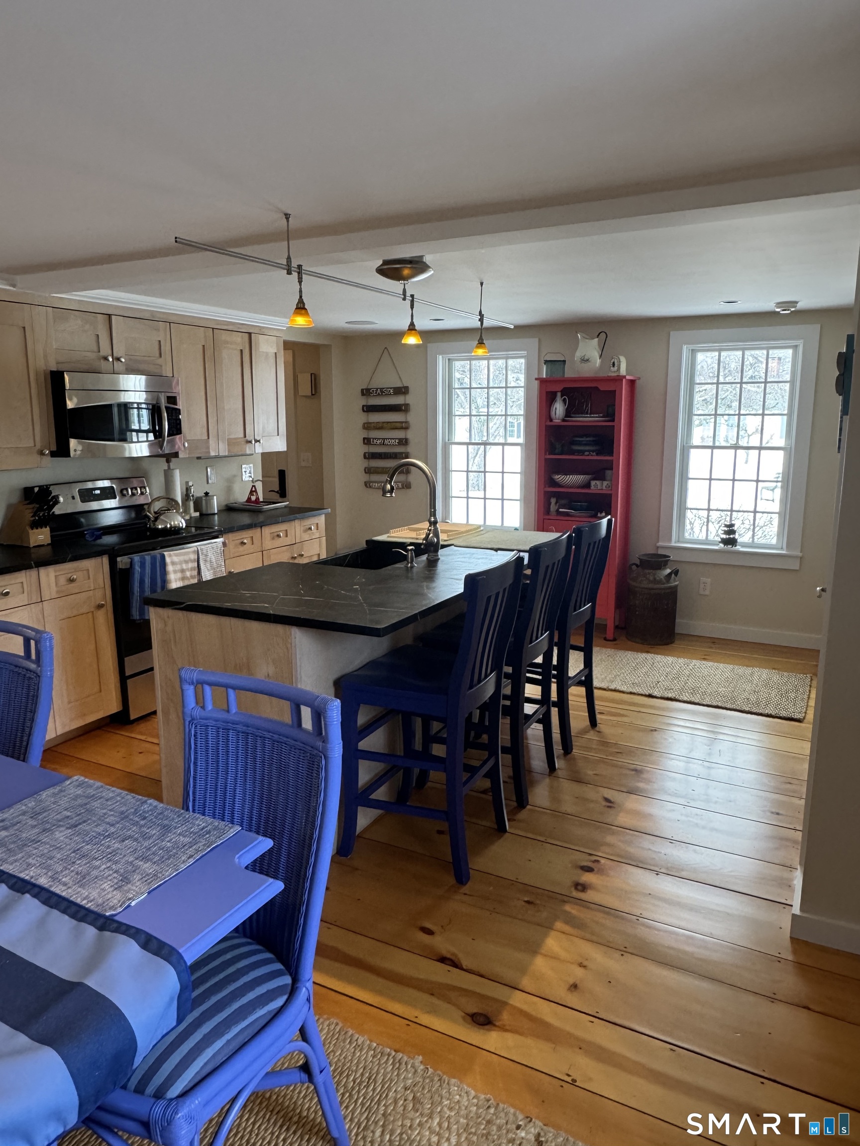 84 Waterside Lane, Unit 3 Clinton, CT 06413 - Photo 11 of 37 a kitchen with stainless steel appliances granite countertop a stove a sink dishwasher a dining table and chairs with wooden floor