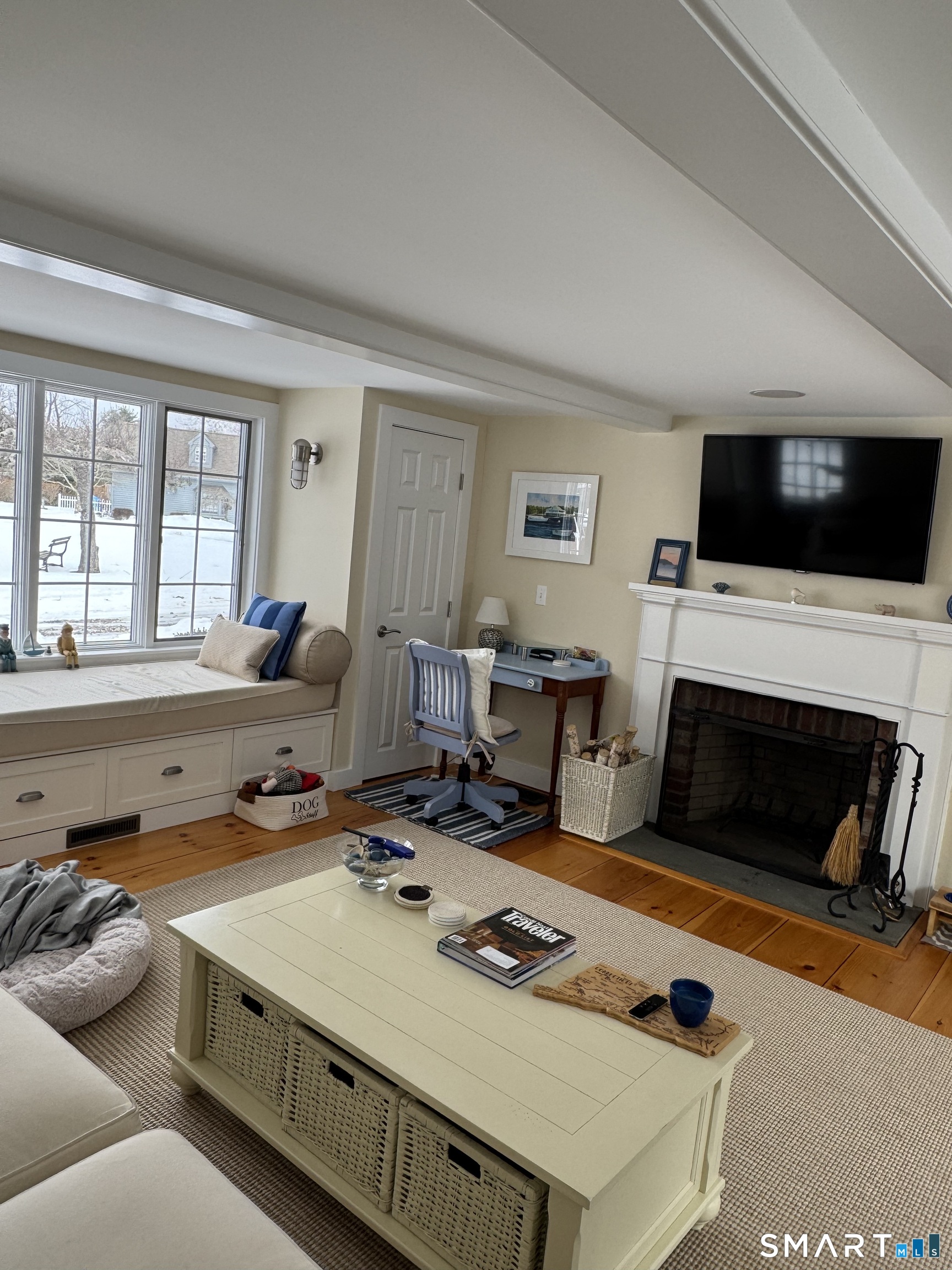 84 Waterside Lane, Unit 3 Clinton, CT 06413 - Photo 16 of 37 a living room with furniture a flat screen tv and a fireplace