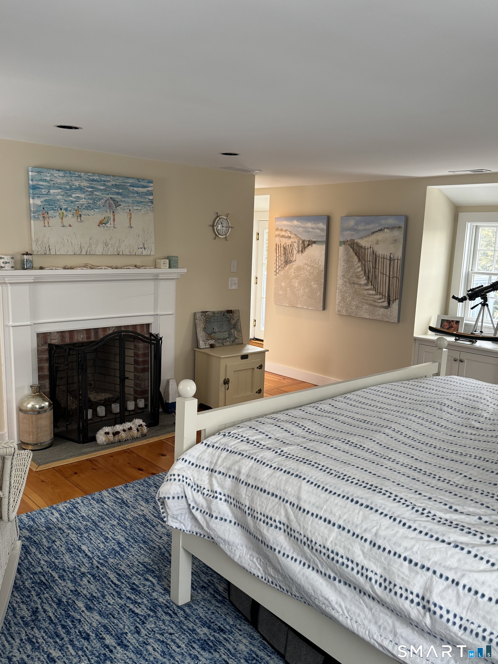 84 Waterside Lane, Unit 3 Clinton, CT 06413 - Photo 32 of 37 a bedroom with a bed and a fireplace