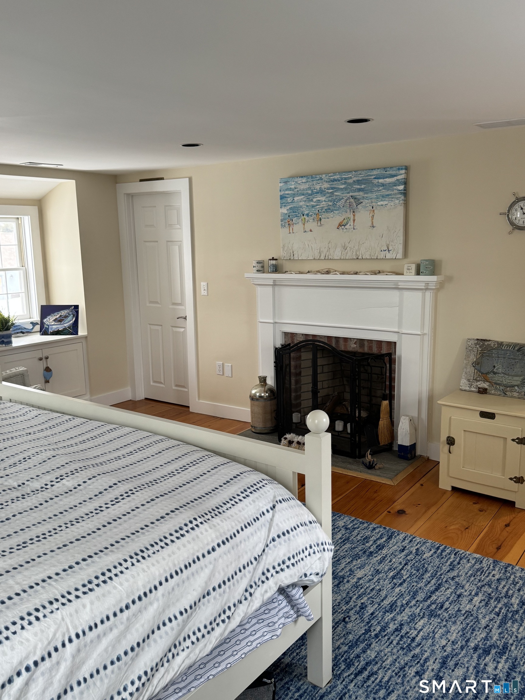 84 Waterside Lane, Unit 3 Clinton, CT 06413 - Photo 33 of 37 a bedroom with a bed and a fireplace