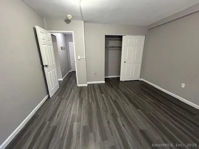 a view of a room with wooden floor and staircase