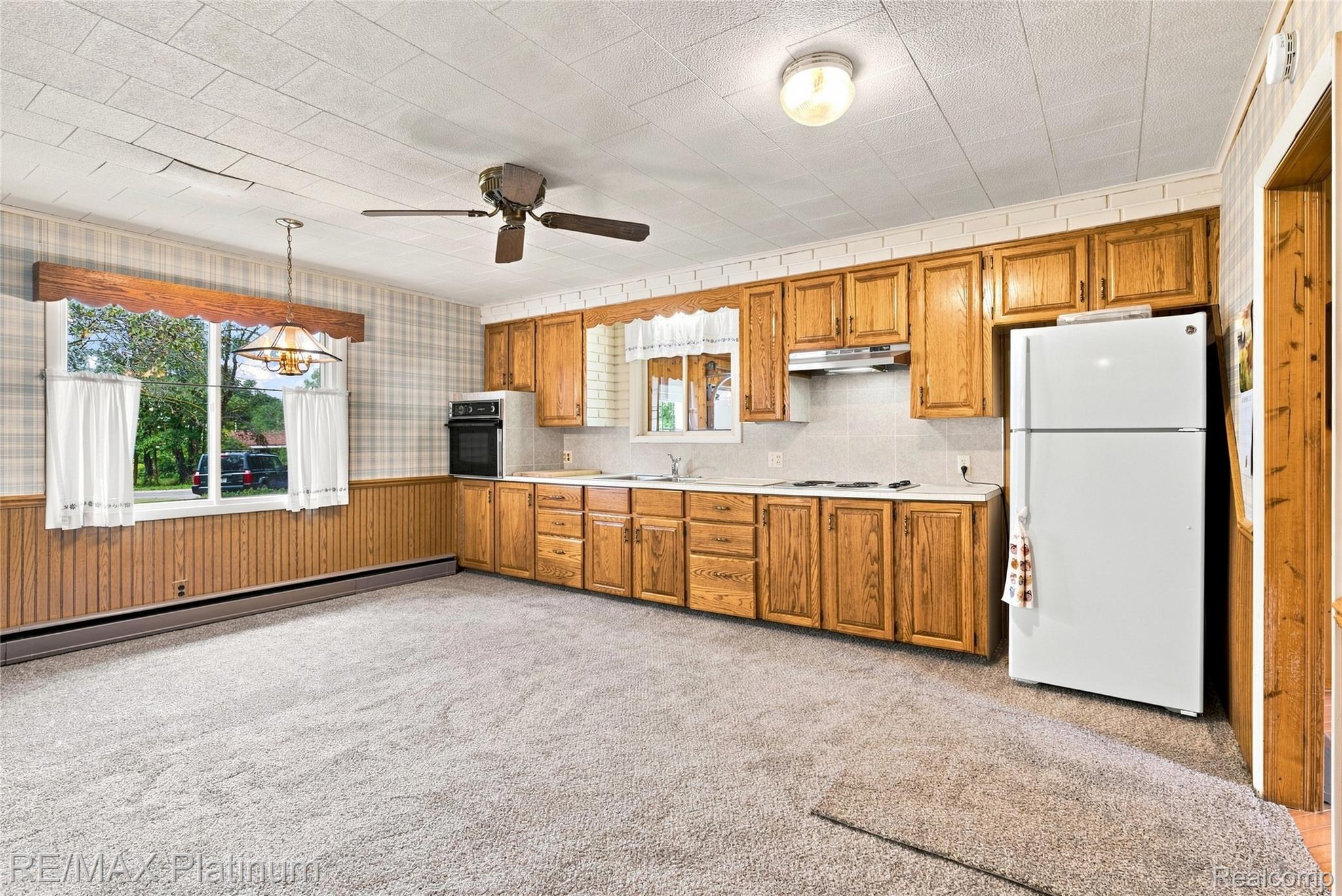 1609 West Dewey Road Owosso, MI 48867 - Photo 10 of 32 Kitchen featuring wood cabinetry, built-in oven, and a ceiling fan