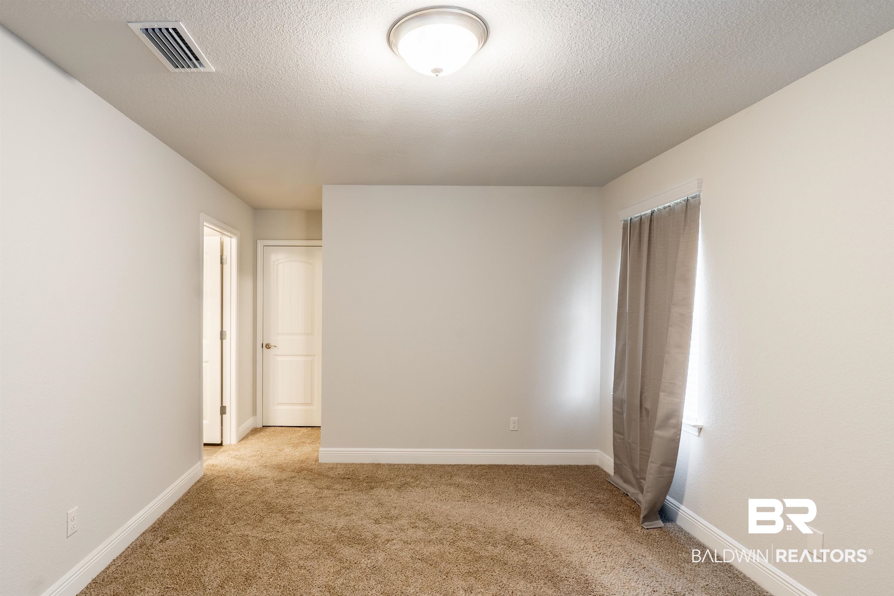 1906 Stonepine Drive South Semmes, AL 36575 - Photo 21 of 30 Unfurnished bedroom featuring light carpet and a textured ceiling