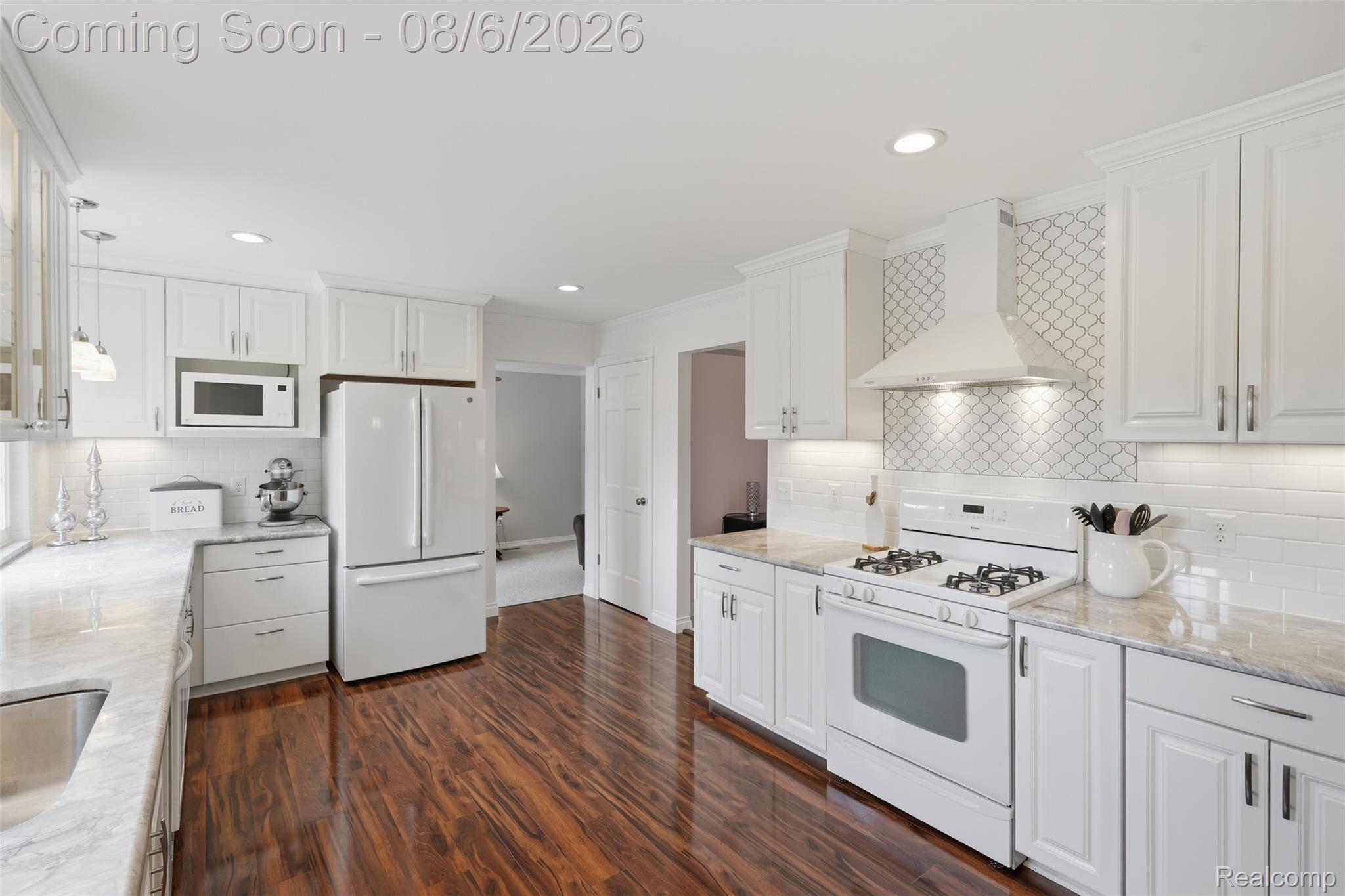3585 Loon Lake Road Wixom, MI 48393 - Photo 4 of 40 Bright kitchen featuring white cabinetry and wood-finish flooring