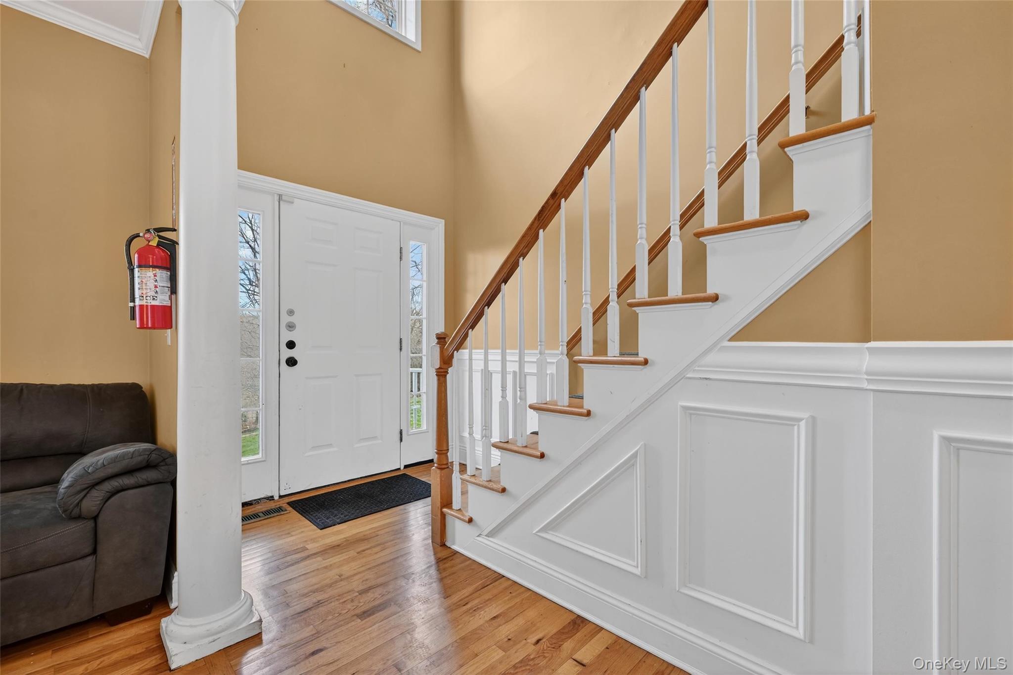 1071 Craigville Road Chester, NY 10918 - Photo 8 of 48 Foyer with healthy amount of natural light, light wood-style flooring, a decorative wall, and a high ceiling
