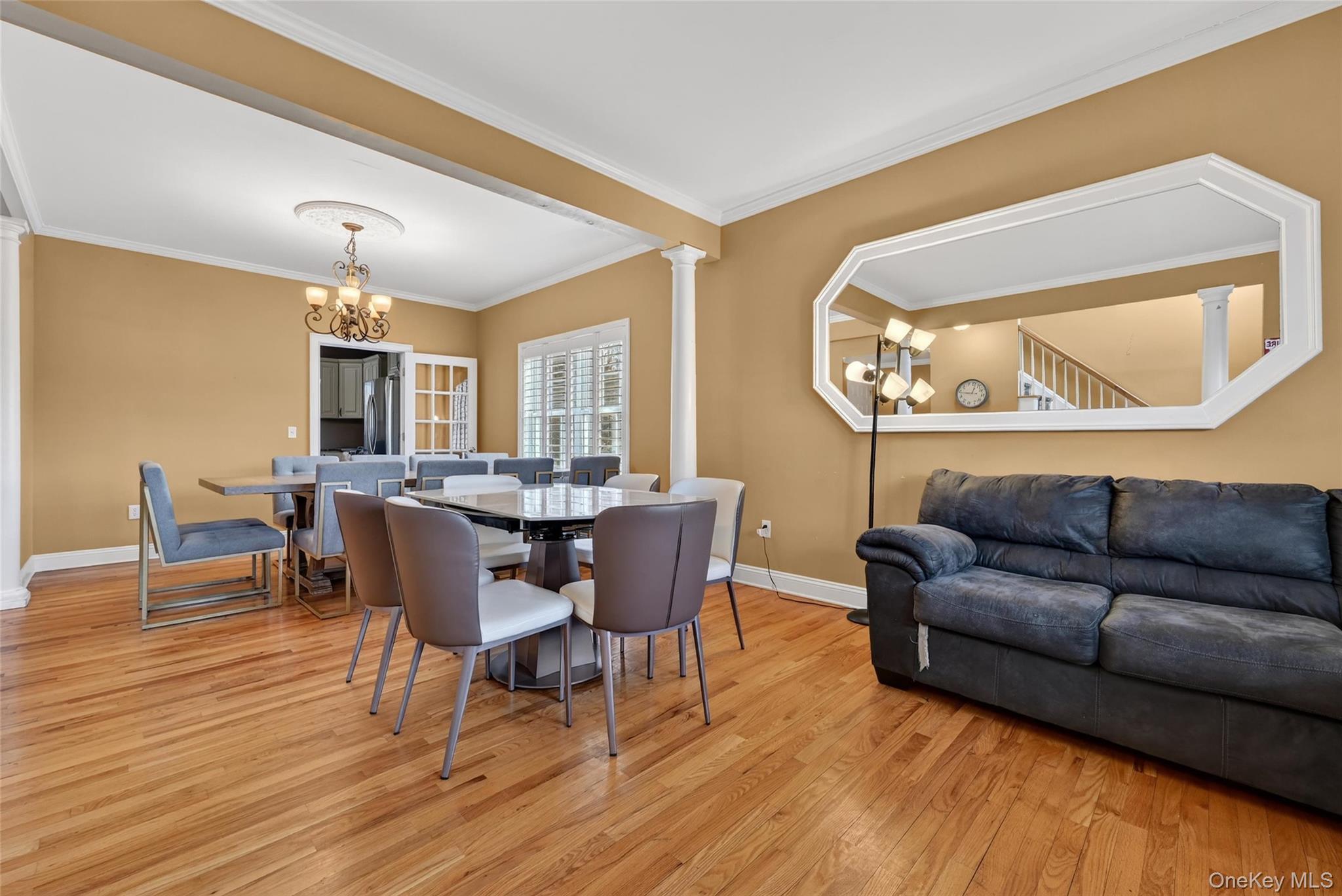1071 Craigville Road Chester, NY 10918 - Photo 9 of 48 Dining area featuring hanging lights, ornate columns, light wood-style floors, and crown molding