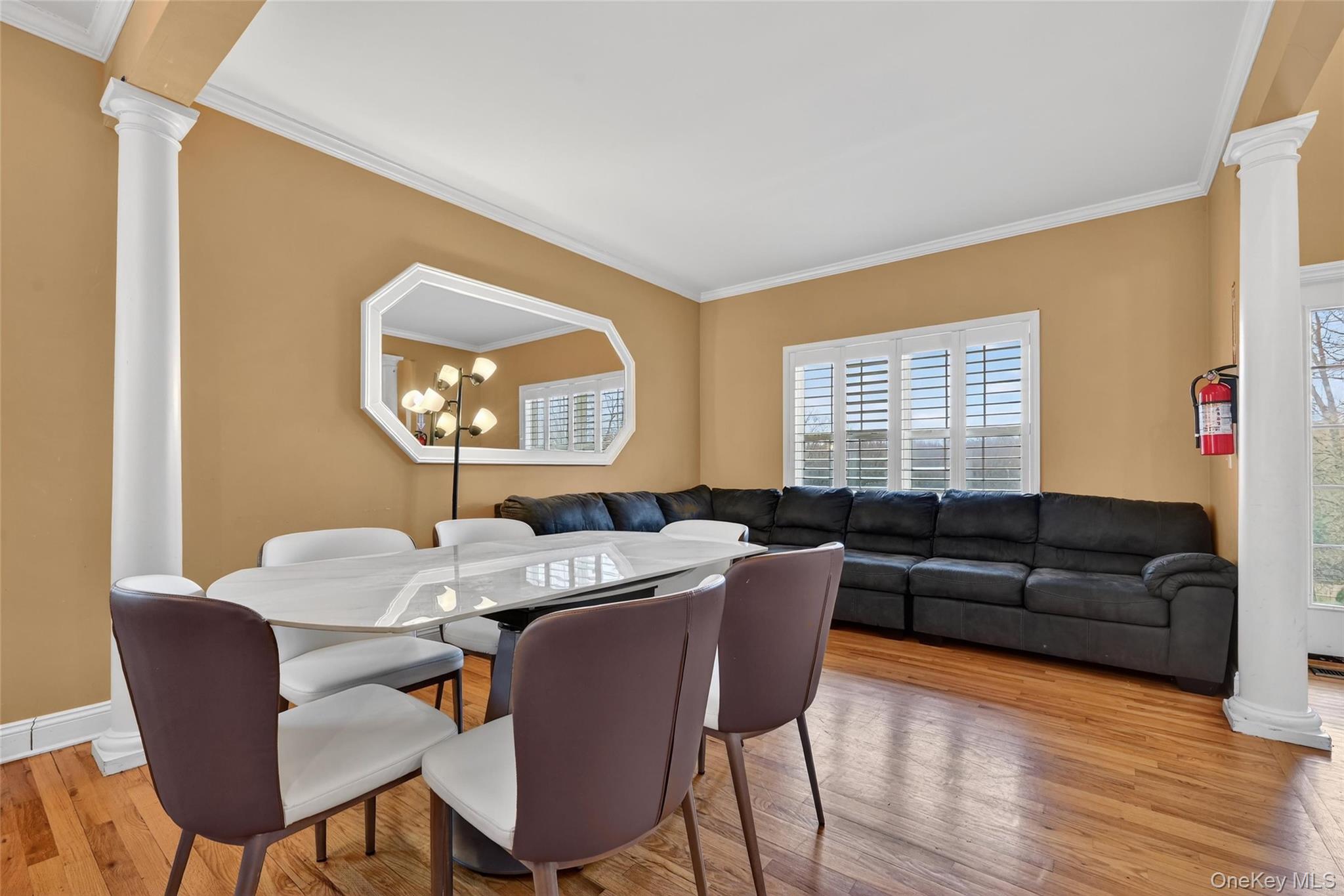 1071 Craigville Road Chester, NY 10918 - Photo 10 of 48 Dining room featuring decorative columns, ornamental molding, and light wood finished floors