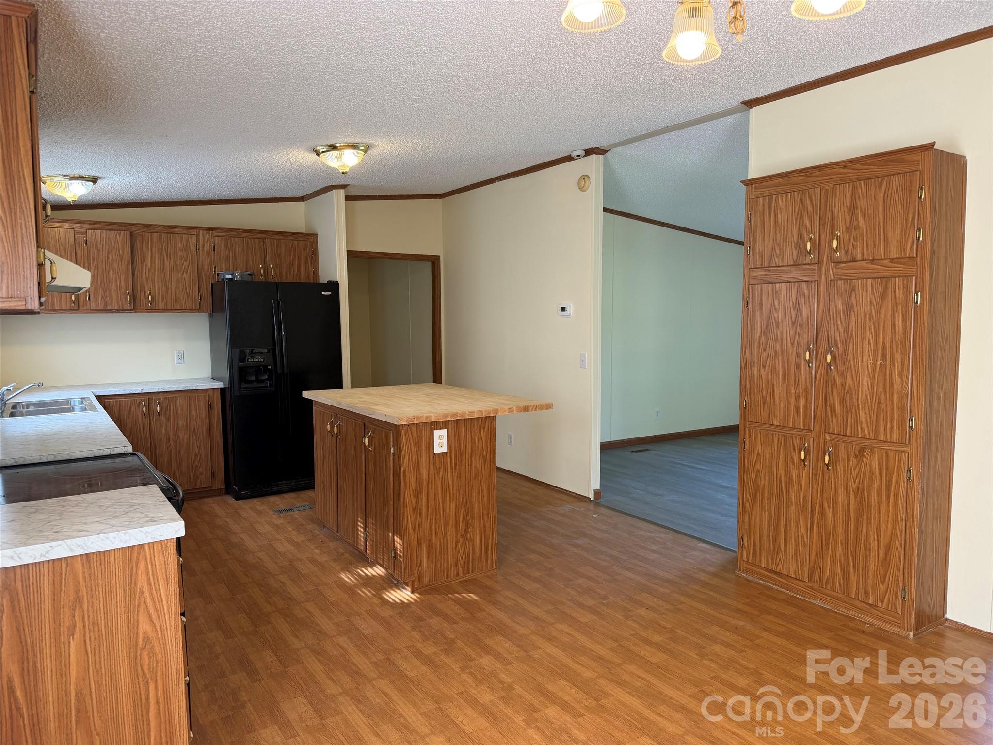 7141 Lingerfelt Road Vale, NC 28168 - Photo 12 of 25 a kitchen with stainless steel appliances a refrigerator and wooden floor