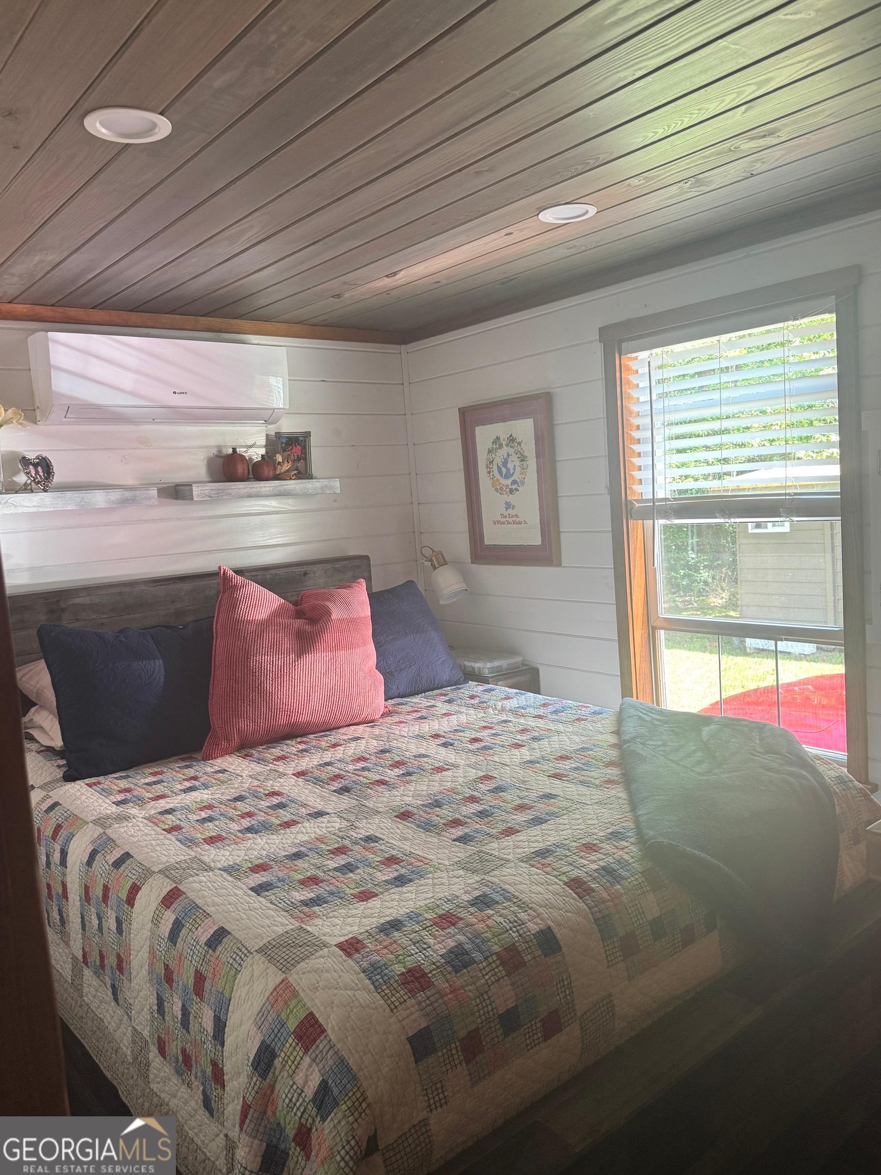 4960 Laurel Lodge Road Clarkesville, GA 30523 - Photo 11 of 21 a bedroom with a large bed and a window