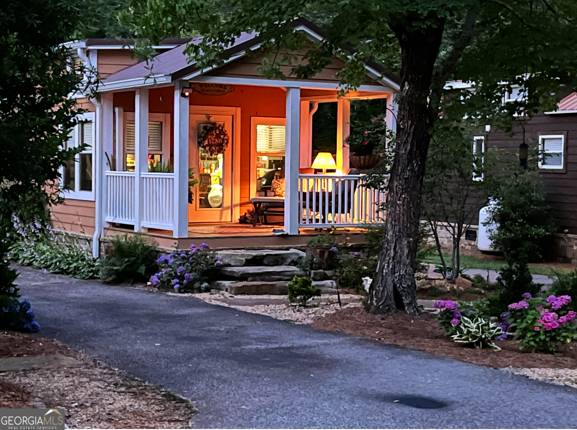 4960 Laurel Lodge Road Clarkesville, GA 30523 - Photo 4 of 21 a front view of a house with a yard outdoor seating and entertaining space
