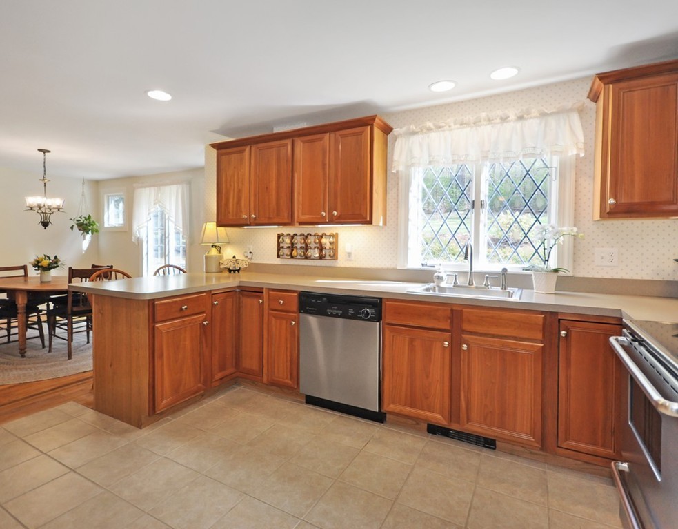 51 Harvard Road Stow, MA 01775 - Photo 4 of 17 a kitchen with stainless steel appliances granite countertop wooden cabinets a sink and a large window